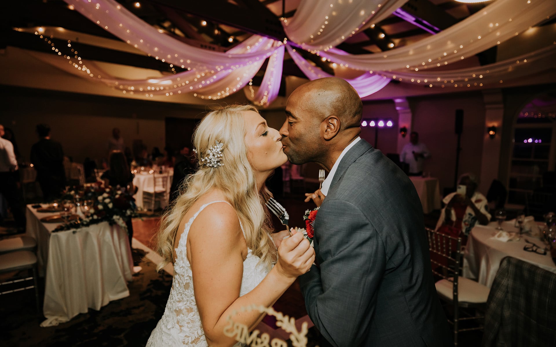 Interracial couple kissing on their wedding day